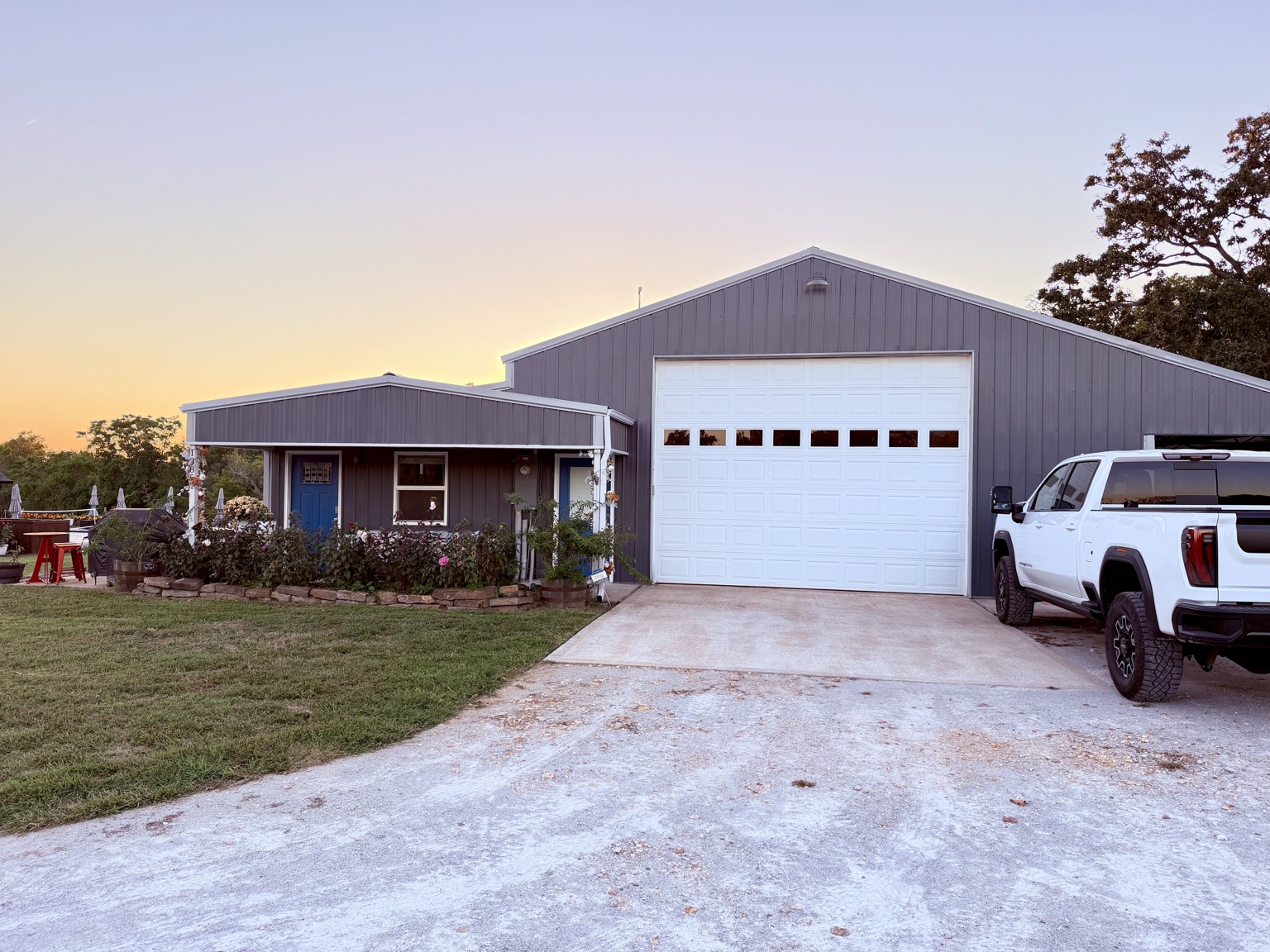Guest house and garage with a white truck parked to the right of the garage door, showing where guests should park