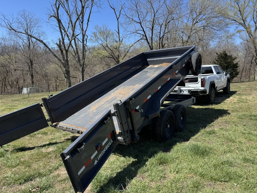 Iron Bull dump trailer with its bed raised on the property