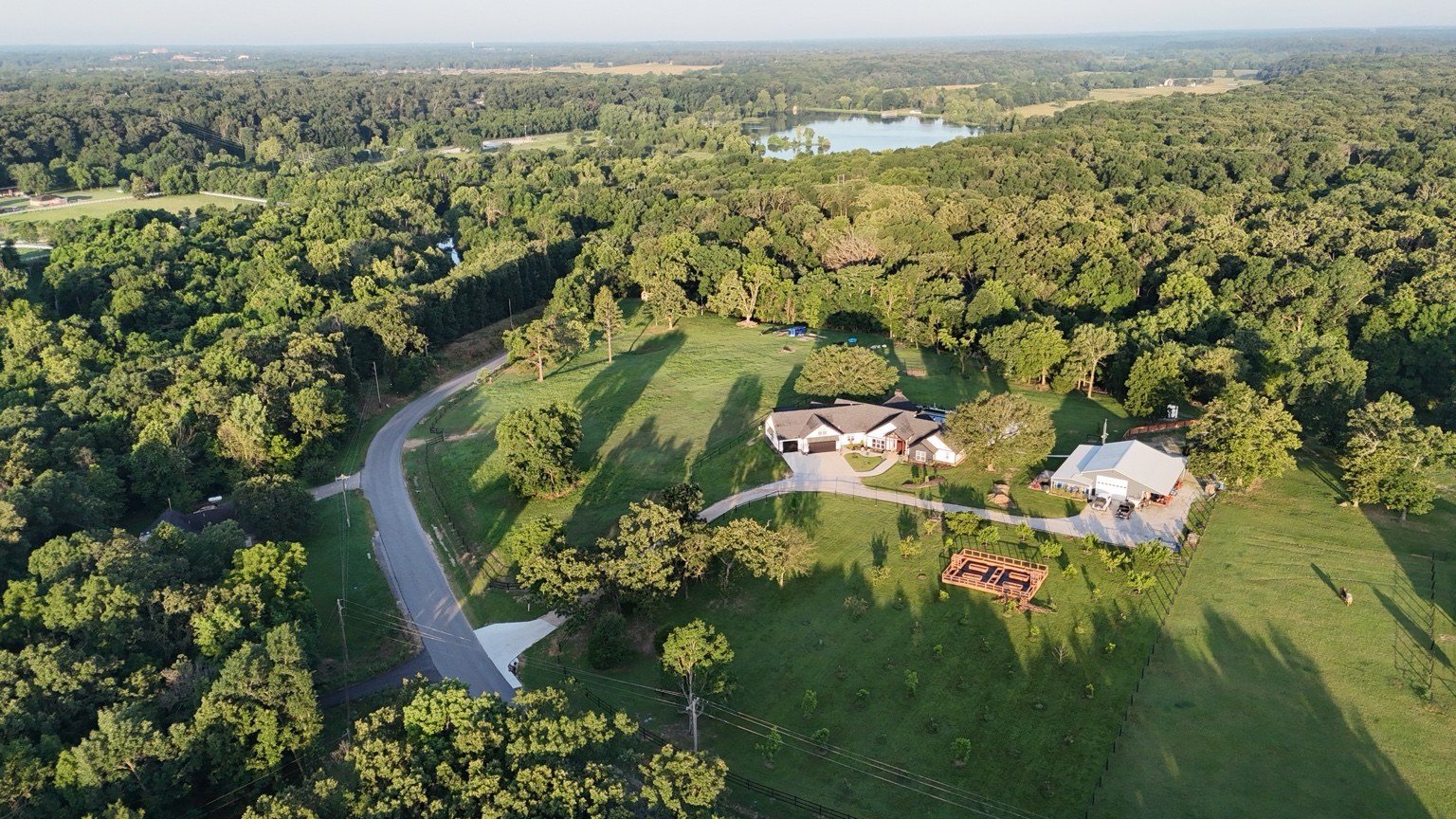 Aerial view of the property and surrounding trees